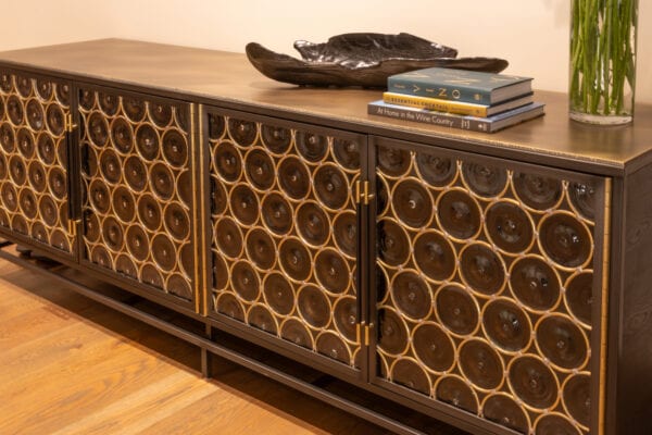 Console table with books, a vase, and a decorative piece of artwork