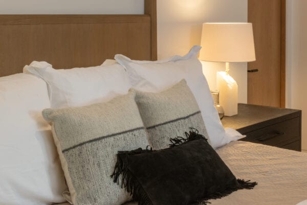 Bed throw pillows and side table with lamp