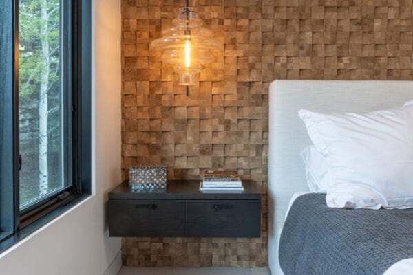 Lightning fixture in front of textured wall.