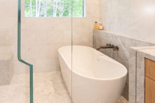 Large bathtub in shower with window.